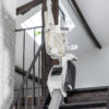 Folded up stairlift at top of stairs