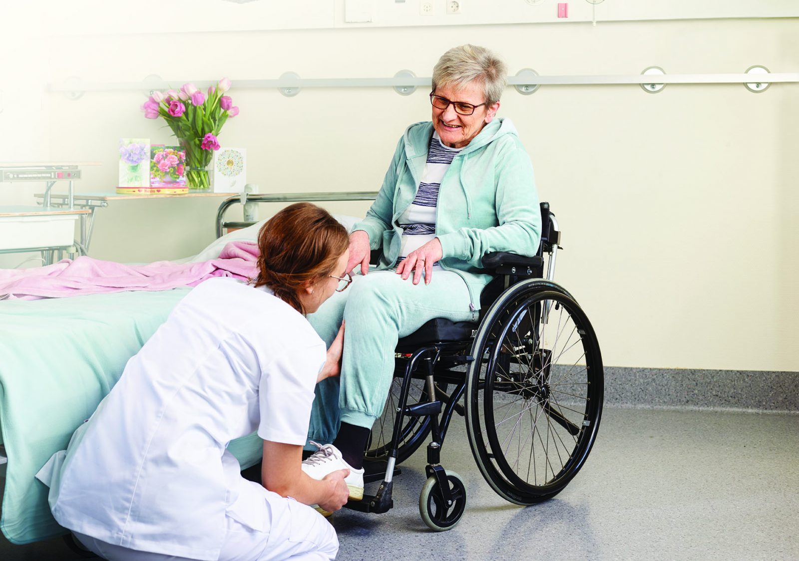 Positioning womans leg in wheelchair