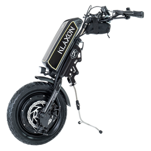 Front view of the Klaxon Klick Race wheelchair power add-on, featuring a 14-inch wheel with all-road tyre, disc brakes, and ergonomic handlebar controls, isolated on a white background.