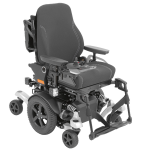 Isolated product view of the Ottobock Juvo B5 MWD powerchair, featuring a specialized Mid-Wheel Drive (MWD) base for superior indoor maneuverability and a tight turning radius. The powerchair is shown with a modular grey frame, a high-performance seating system (such as the VAS or Contour package), and a six-wheel suspension system designed for intuitive handling and stability both indoors and out, isolated on a white background.