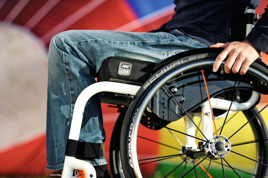 JAY Lite Cushion, on a white wheelchair with mans legs.