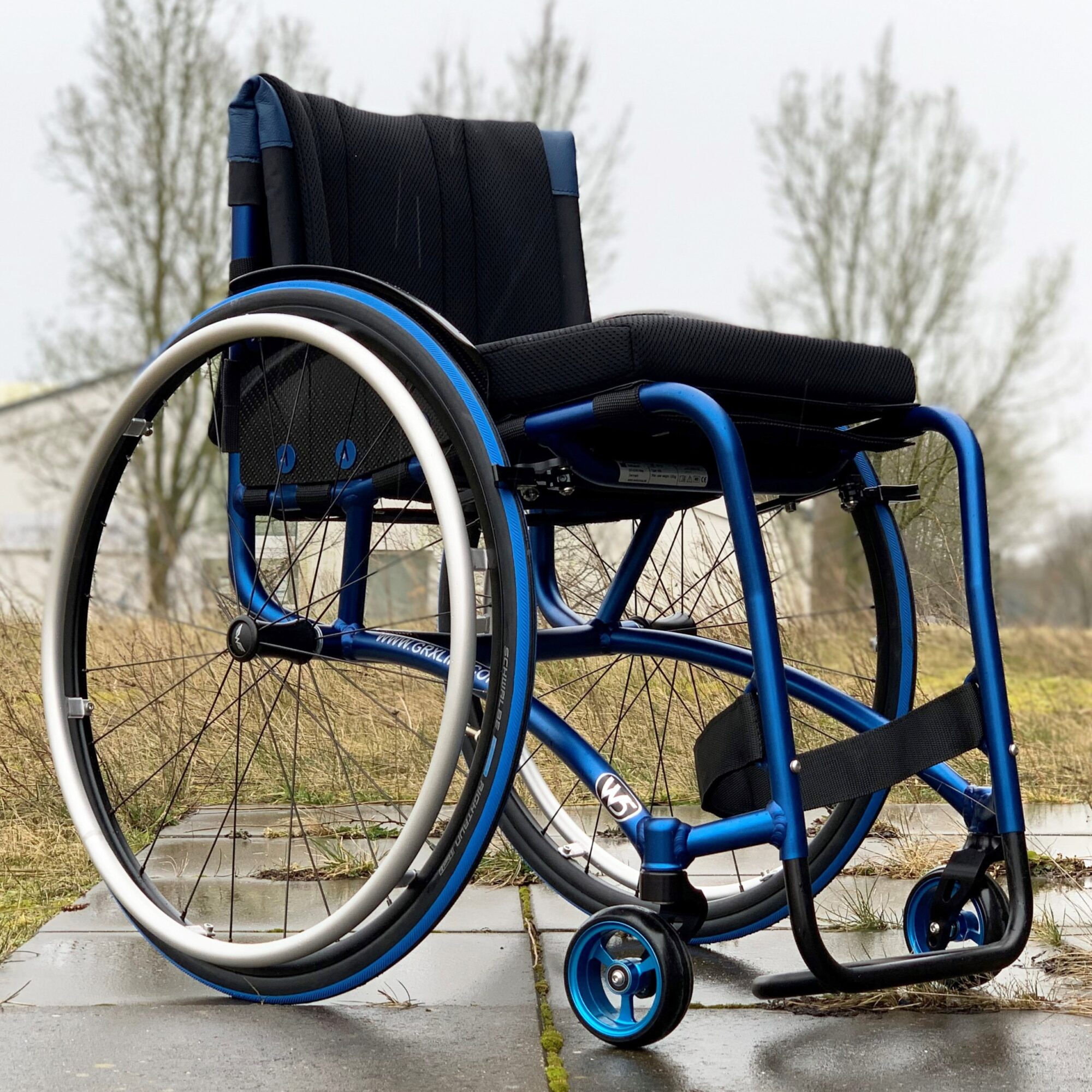 Blue Anodised Wolturnus W5 SL wheelchair outdoors