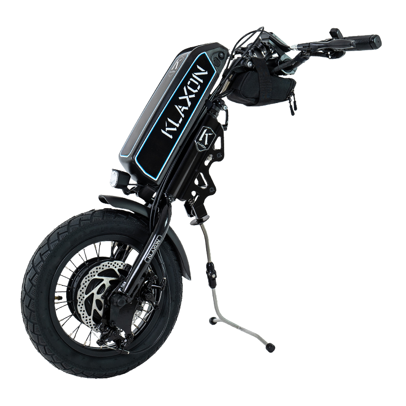 Front view of the Klaxon Klick Power wheelchair handbike power add-on, featuring a 14-inch wheel with a smooth tread tyre, mechanical disc brakes, and an integrated lithium battery, isolated on a white background.