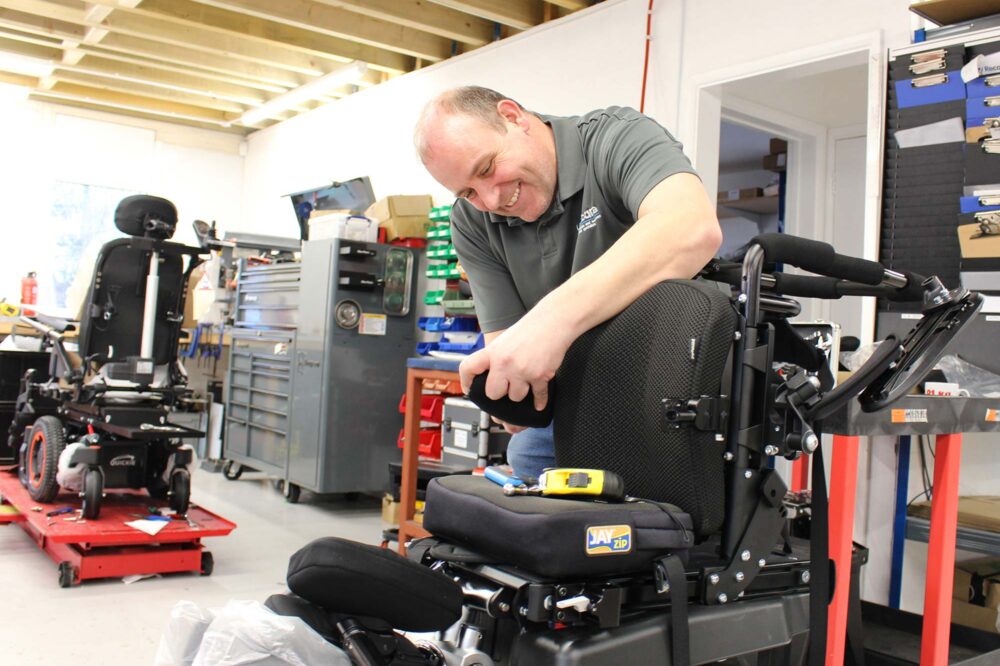 Fitting powerchair armrests to the seat frame