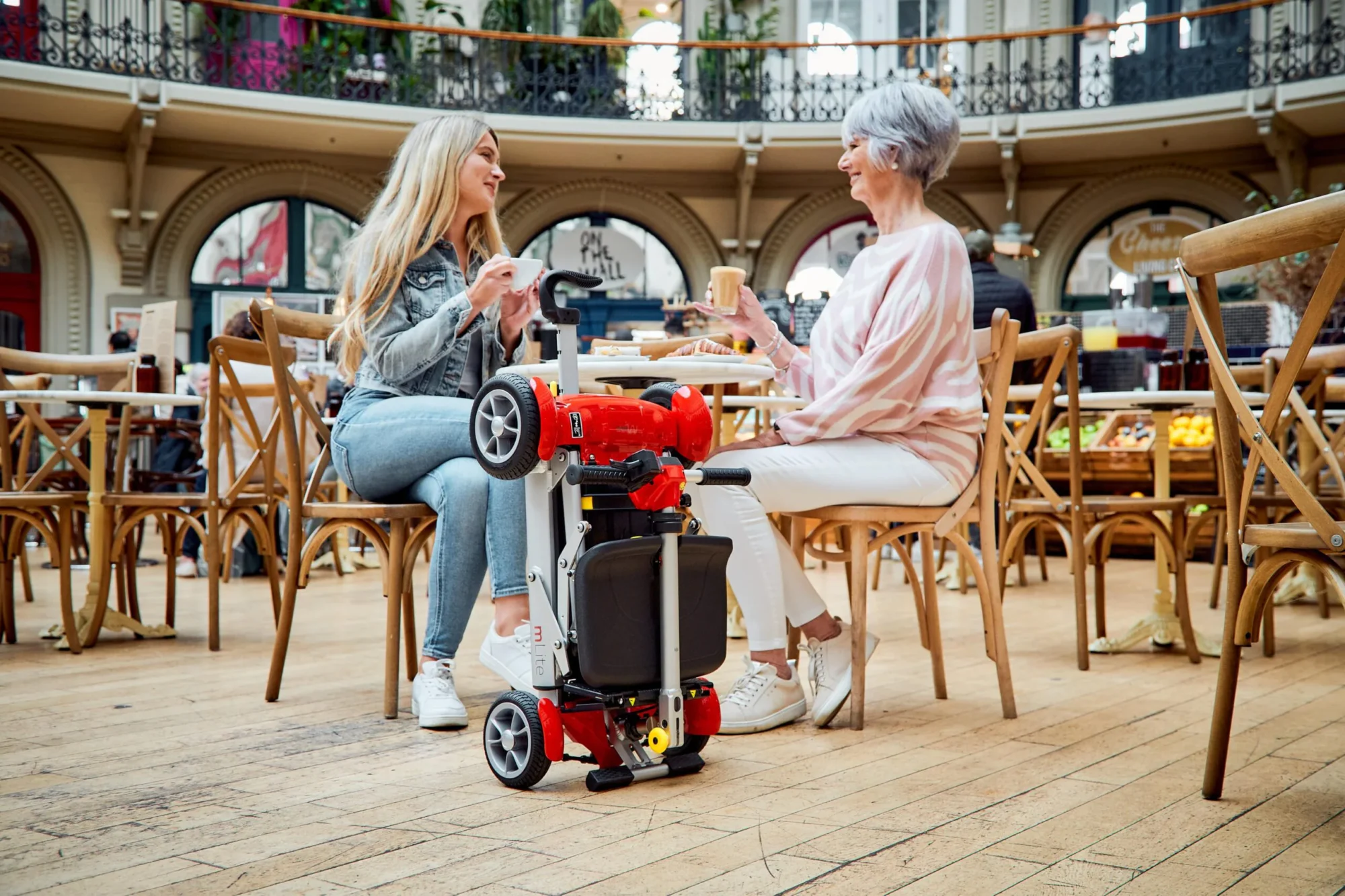 folded mobility scooter at cafe table
