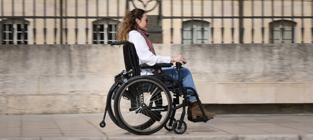 Panoramic banner featuring the Benoit Systèmes Light Drive 3 wheelchair power add-on, showing the motorized unit attached to a manual wheelchair in a lifestyle setting.