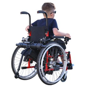 Benoit Systèmes Light Drive Mini 3 pediatric power add-on attached to a child's red manual wheelchair, isolated without background.