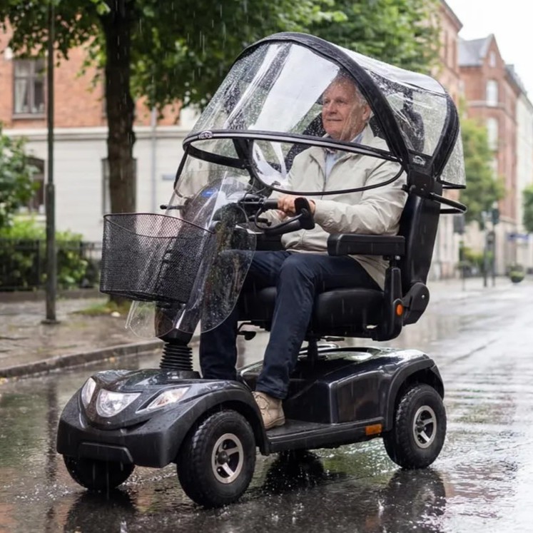 Mobility scooter with Veltop Comfort Mobil-C canopy being driven in the rain