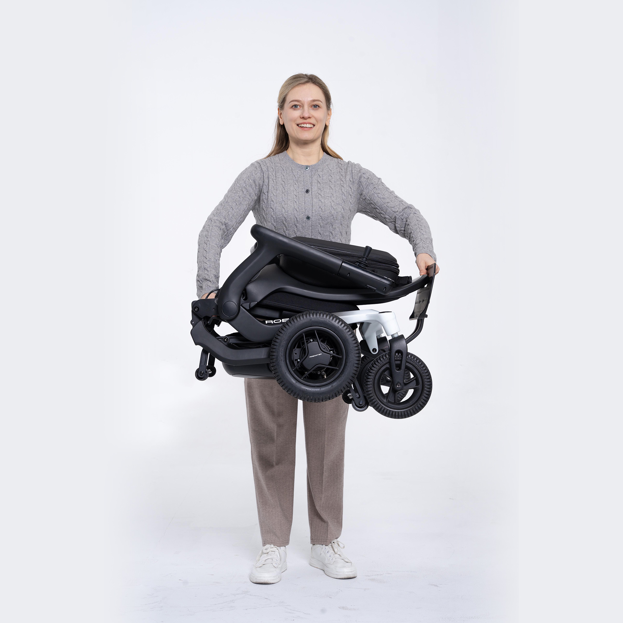Woman holding a Rebooter E80 foldable portable wheelchair